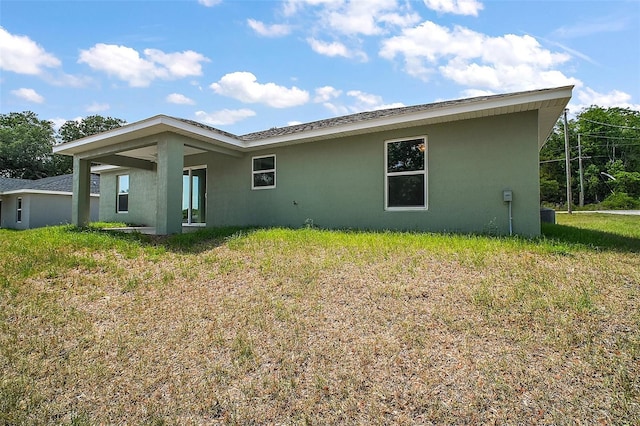 rear view of property with stucco siding