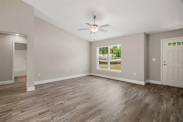 unfurnished living room with ceiling fan, wood finished floors, and baseboards
