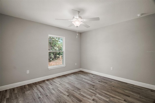 spare room featuring ceiling fan, wood finished floors, and baseboards