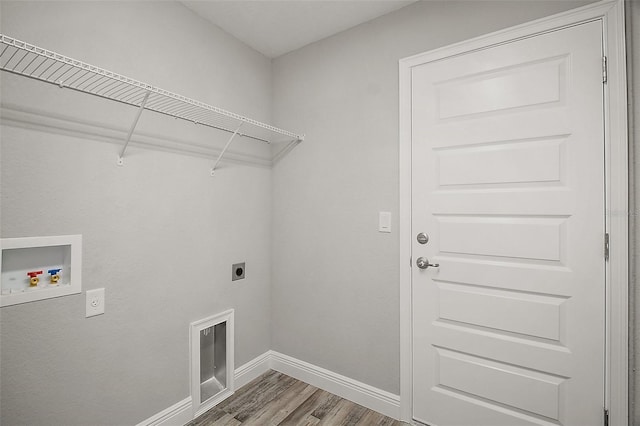 laundry area featuring hookup for a washing machine, wood finished floors, laundry area, hookup for an electric dryer, and baseboards