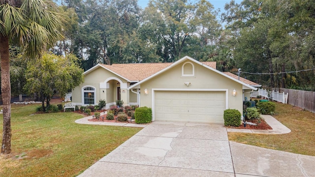 single story home featuring a garage and a front yard