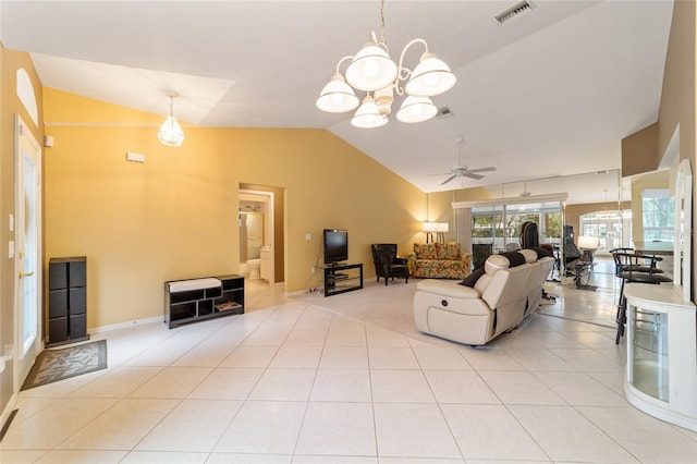 tiled living room with ceiling fan with notable chandelier and lofted ceiling