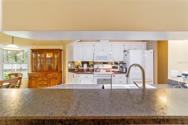 kitchen featuring white cabinets, white appliances, decorative light fixtures, and sink