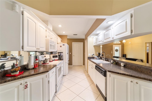 kitchen featuring white cabinets, white appliances, light tile patterned flooring, and sink