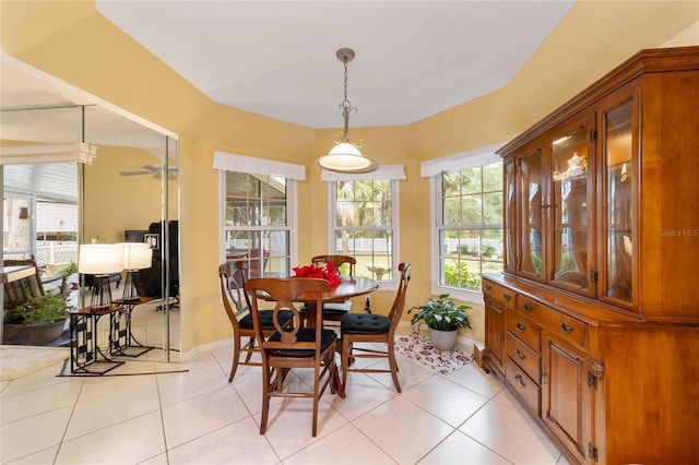 dining space with ceiling fan and light tile patterned floors