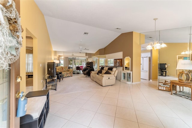 tiled living room featuring ceiling fan with notable chandelier and high vaulted ceiling