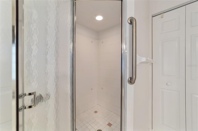 bathroom with a shower with door