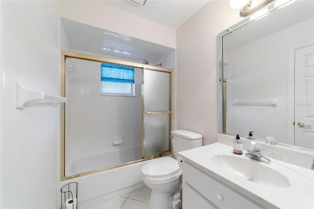 full bathroom featuring tile patterned floors, shower / bath combination with glass door, vanity, and toilet