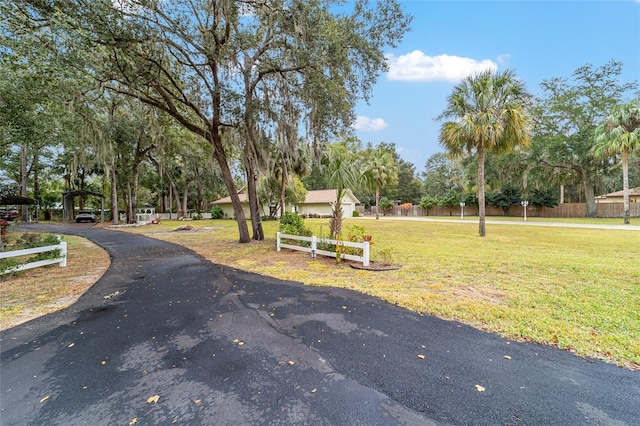 view of property's community with a yard