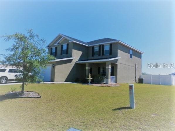 view of front facade featuring central AC and a front lawn