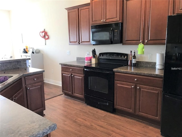 kitchen featuring light hardwood / wood-style flooring and black appliances