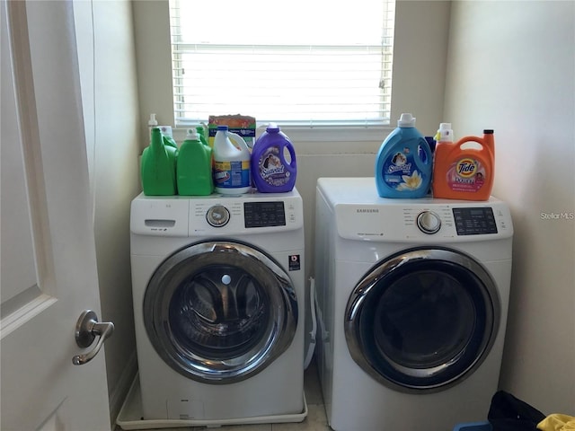 washroom with a wealth of natural light and washer and clothes dryer