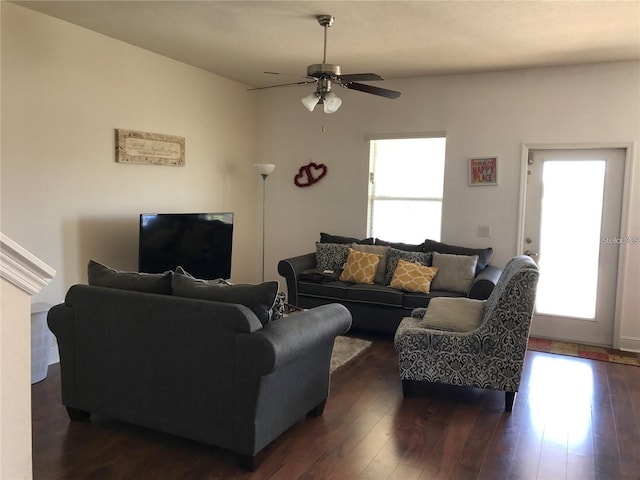 living room featuring ceiling fan and dark hardwood / wood-style flooring