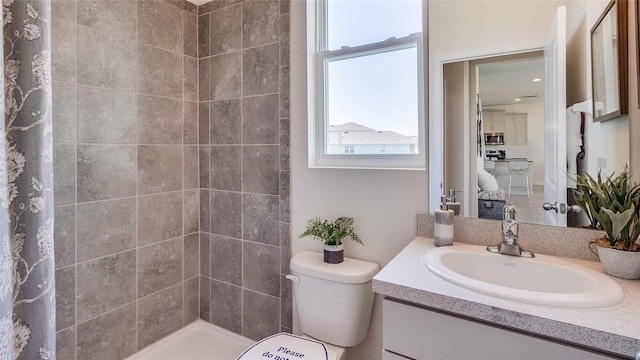 bathroom with a shower with curtain, vanity, and toilet