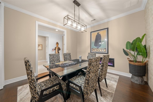 dining space featuring dark hardwood / wood-style floors and crown molding