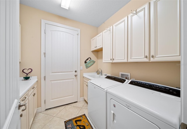 9146 SW 65th Loop, Ocala, FL 34481 - laundry room with washing machine and clothes dryer, cabinet space, light tile patterned floors, baseboards, and a textured ceiling