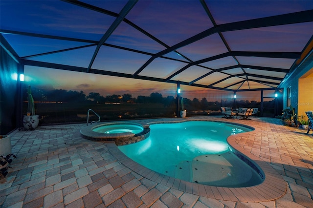 pool at dusk featuring a lanai, an in ground hot tub, and a patio