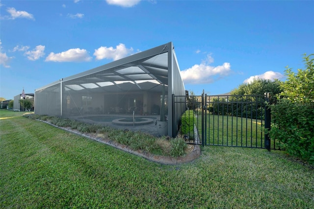 exterior space featuring glass enclosure, a lawn, and a pool with hot tub