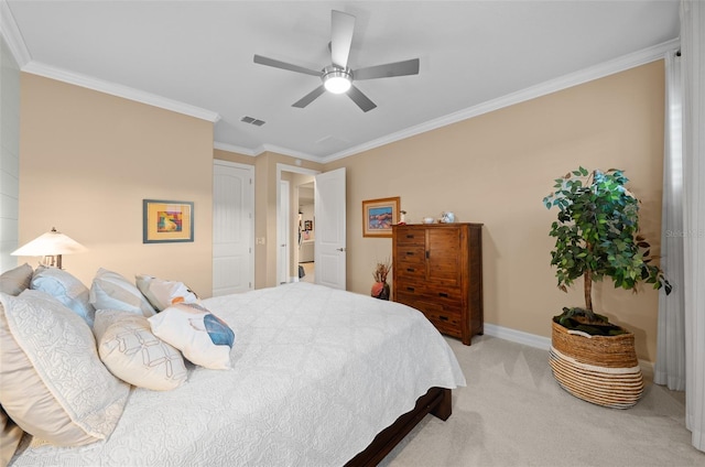 carpeted bedroom with ceiling fan and ornamental molding