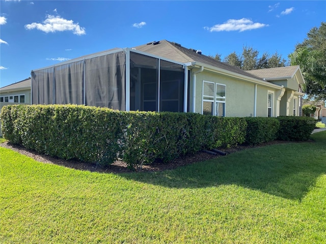 view of side of property with a lawn