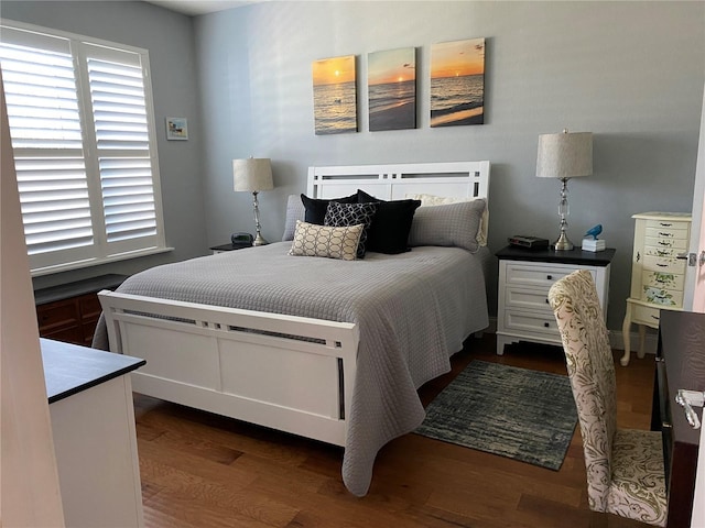 bedroom with dark wood-type flooring