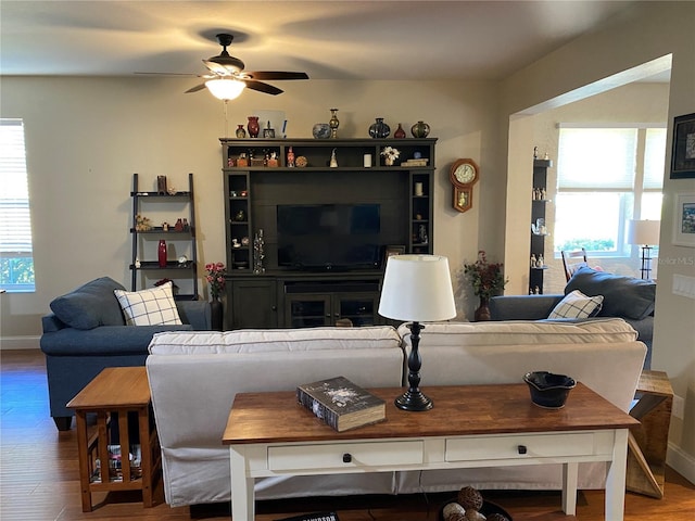 living room featuring hardwood / wood-style floors, ceiling fan, and a healthy amount of sunlight