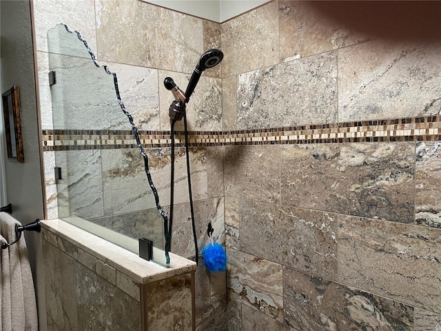 interior details featuring a tile shower