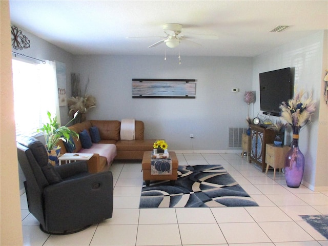 living room featuring ceiling fan and light tile patterned flooring