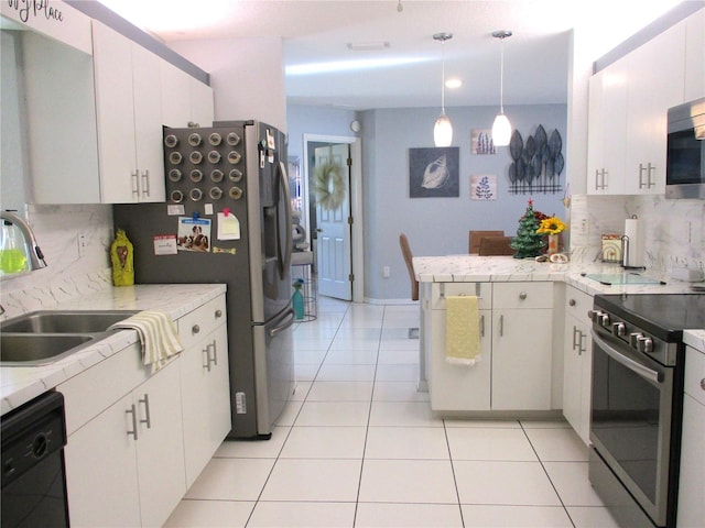 kitchen featuring kitchen peninsula, decorative backsplash, white cabinets, and appliances with stainless steel finishes