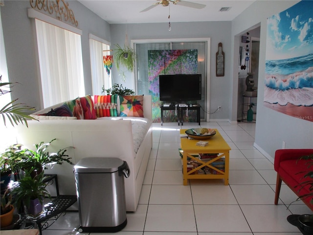 living room with ceiling fan, plenty of natural light, and light tile patterned floors