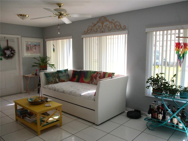 living room with ceiling fan and light tile patterned floors