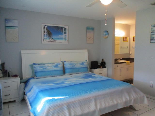 tiled bedroom with ensuite bath and ceiling fan