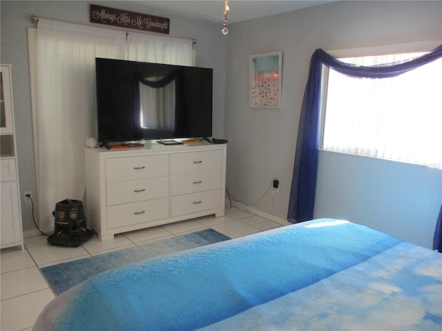 bedroom with light tile patterned floors