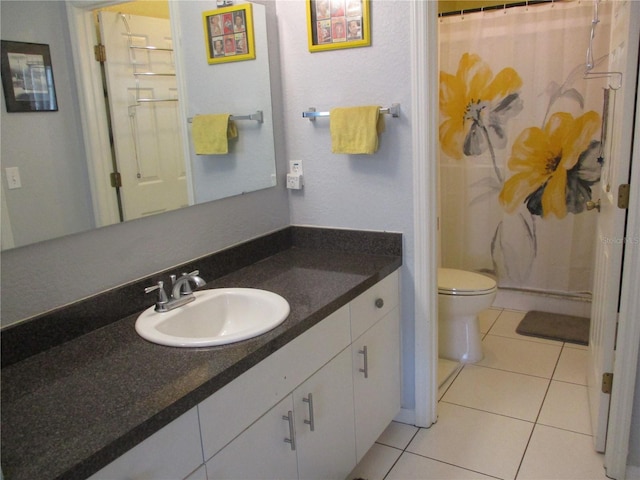 bathroom featuring curtained shower, tile patterned flooring, vanity, and toilet