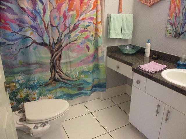 bathroom with tile patterned floors, vanity, and toilet