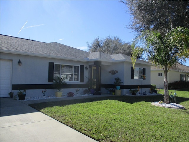 ranch-style home featuring a garage and a front lawn