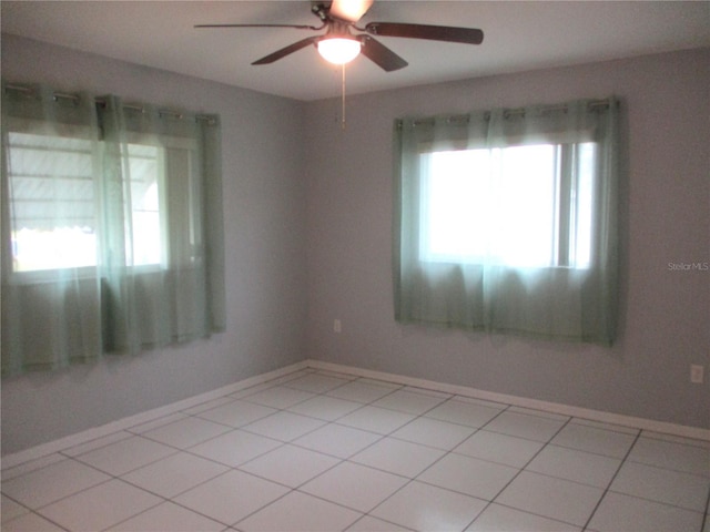 tiled empty room with ceiling fan