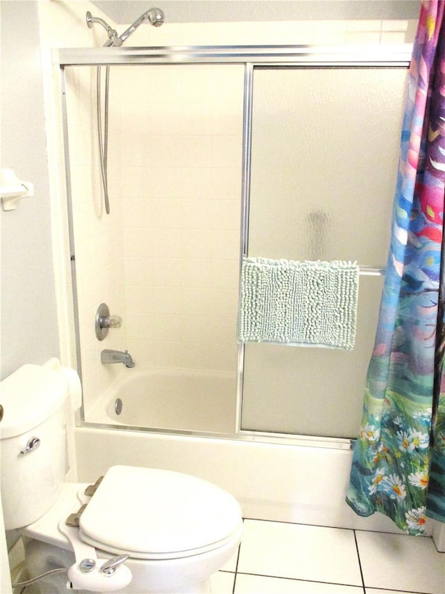 bathroom with shower / bath combo, tile patterned floors, and toilet