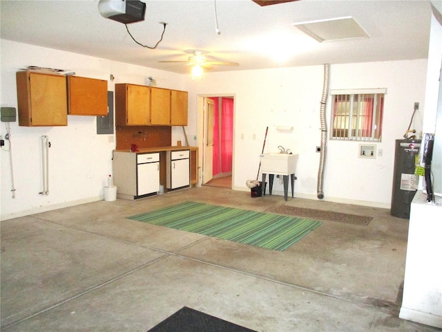 garage with a garage door opener, electric panel, sink, and water heater