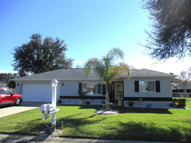 ranch-style house with a front yard, concrete driveway, and a garage