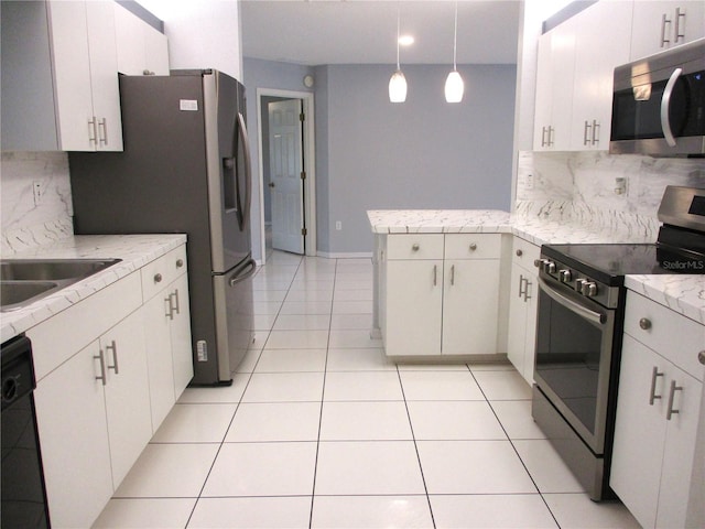 kitchen with white cabinetry, appliances with stainless steel finishes, pendant lighting, and light tile patterned flooring