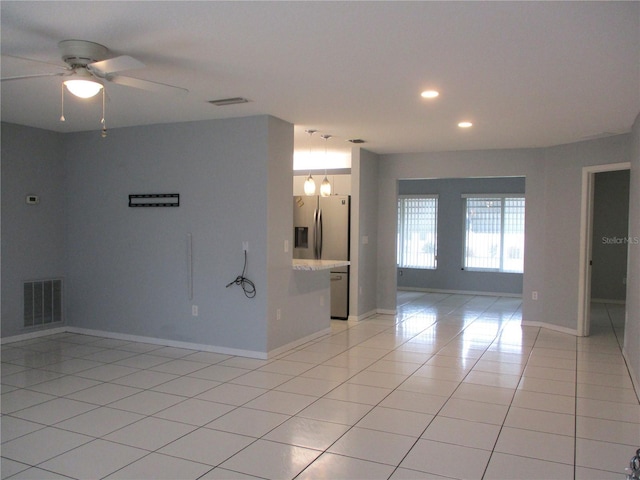 tiled spare room with ceiling fan