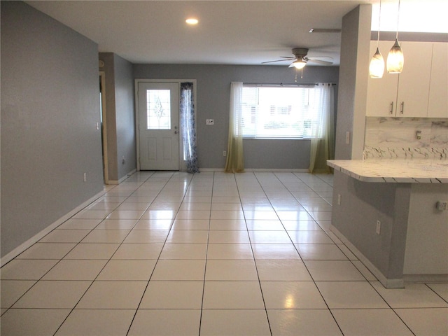 entryway with ceiling fan and light tile patterned floors