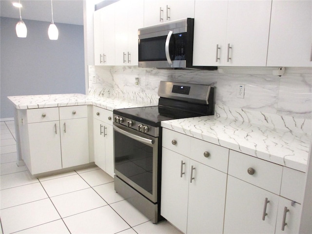 kitchen featuring kitchen peninsula, white cabinets, pendant lighting, stainless steel appliances, and backsplash