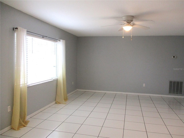 tiled spare room with ceiling fan