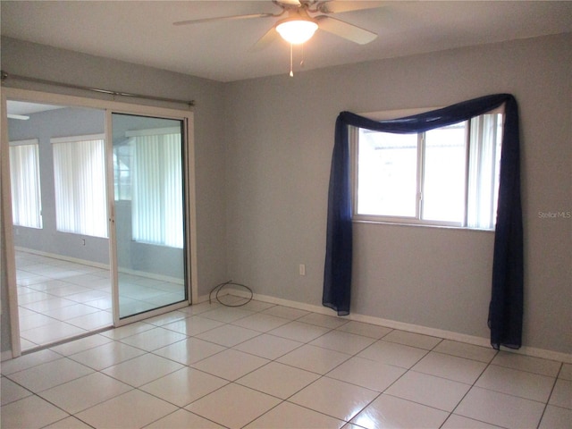 tiled empty room with ceiling fan