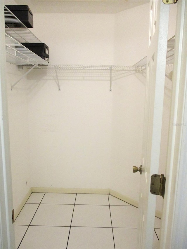 spacious closet featuring light tile patterned floors