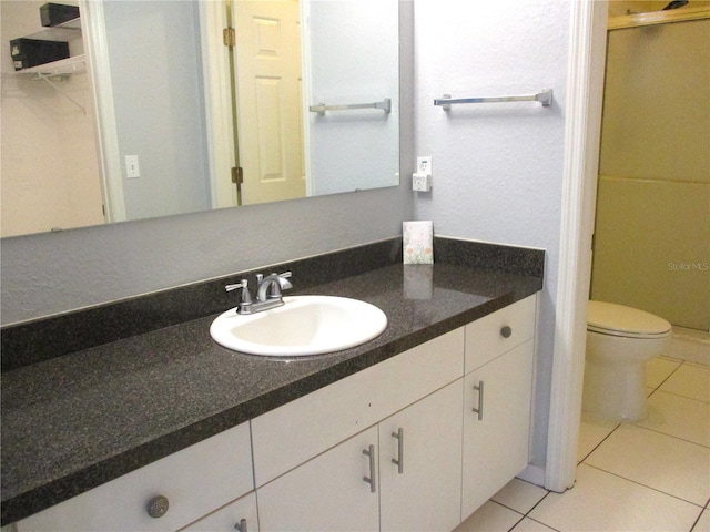 bathroom featuring tile patterned floors, toilet, and vanity