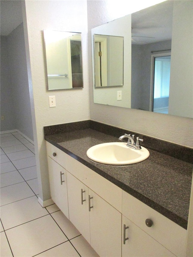 bathroom featuring tile patterned flooring and vanity