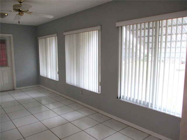 tiled empty room with ceiling fan